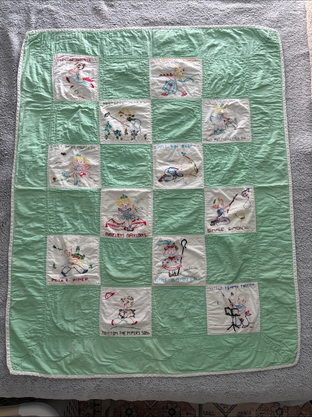 Vintage-Inspired Mint Patchwork Baby Quilt with Embroidered Nursery Rhymes